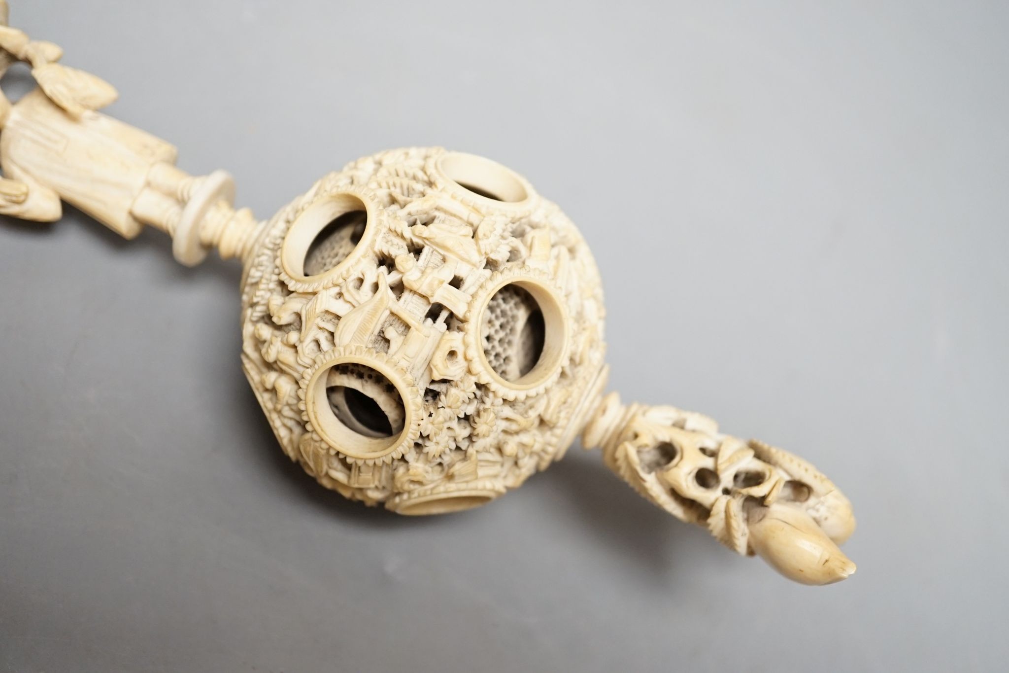 A 19th century Chinese export ivory puzzle ball., 31 cms long including chain.